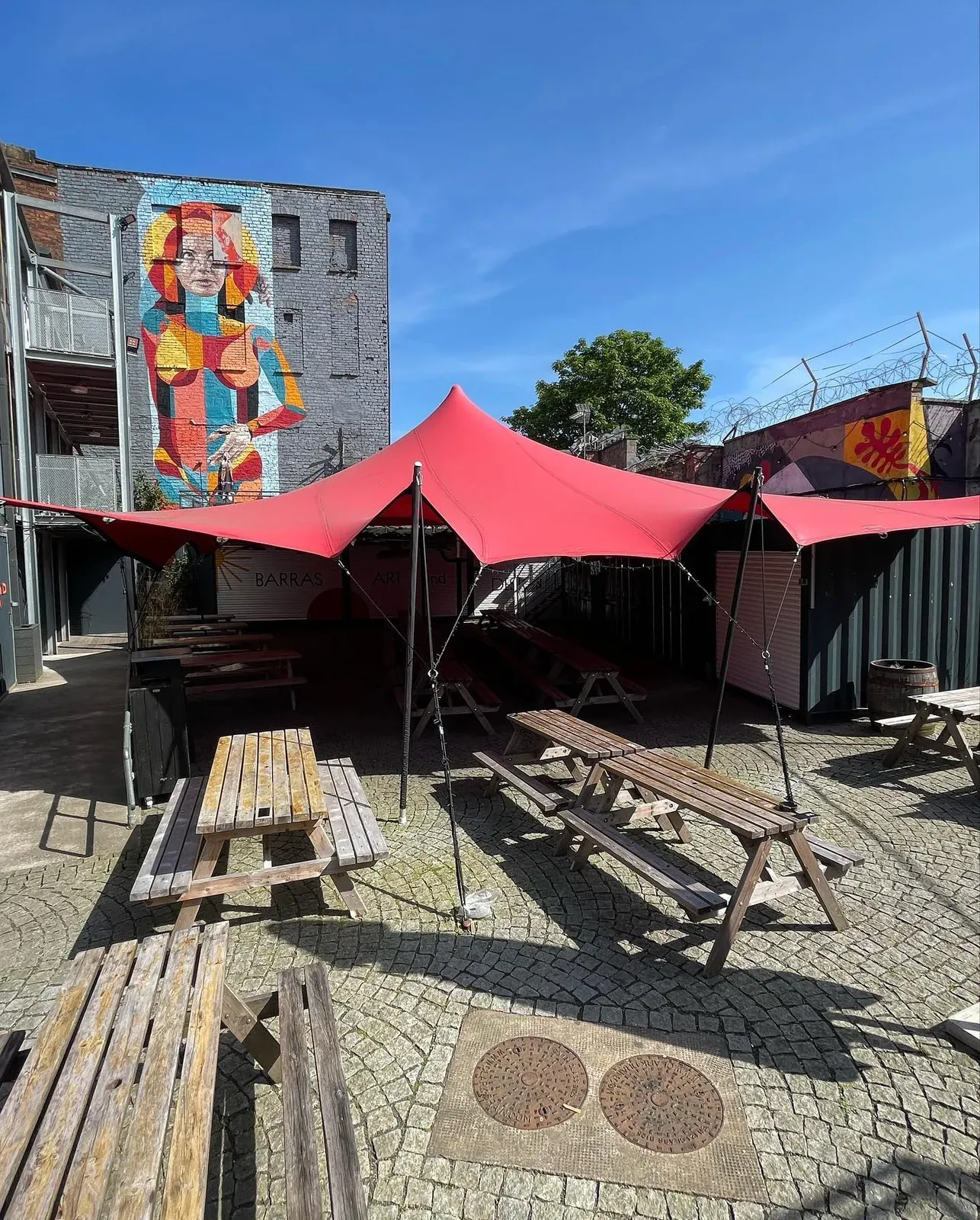 Outdoor tables in BAaD’s container yard at the Barras