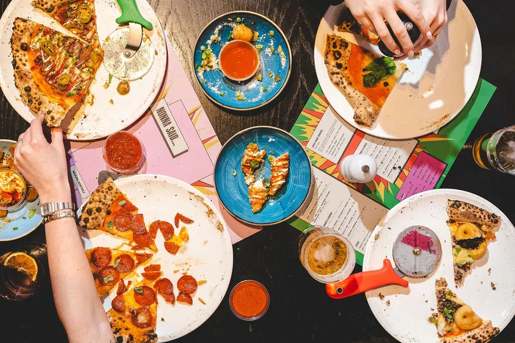 Pizza and drinks on a table at Nonna Said